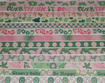 May include: A set of 12 washi tapes with various designs, including butterflies, flowers, smiley faces, and text. The text includes "Overthink it don't overthink it", "Good Vibes", "Groovy baby", and "Be Happy".