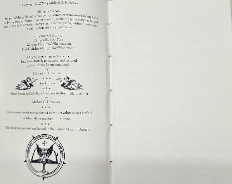 May include: An open book showing text including copyright details, author's name, and publisher information. The text mentions "Kingdom Of Shadow" and "First Edition." The book is described as hand-bound in Italian leather. A circular emblem is at the bottom.