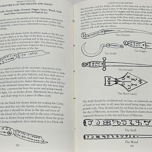 May include: An open book with text and illustrations. The left page discusses a knife and magical art, with a drawing of a knife. The right page displays illustrations of magical tools, including a scimitar, sickle, dagger, and lance.