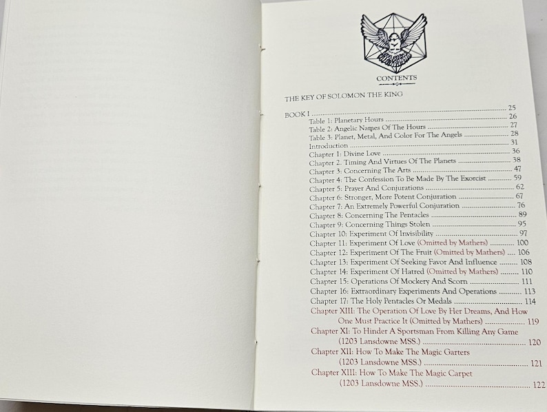May include: An open book displaying the contents page of "THE KEY OF SOLOMON THE KING". The contents include chapters on planetary hours, divine love, and conjurations. A bird graphic is at the top.