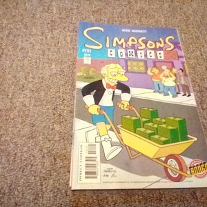 May include: A Simpsons comic book cover featuring a yellow cartoon character pushing a wheelbarrow full of money. The cover text reads "Moe Money!" and "Simpsons Comics #151".