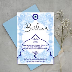 May include: A blue and white invitation card with a blue evil eye charm and the text "Berhan" in black cursive. The card announces a "Sünnet" ceremony for Berhan on July 26, 2025, at La Royal Banqueting Suite in London.