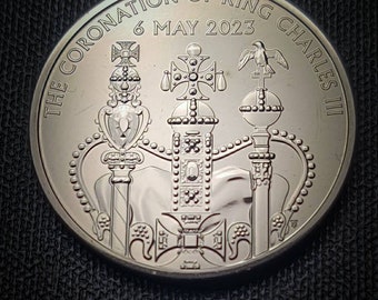 King Charles III coronation 5 pound coin featuring the King wearing a crown for the first time