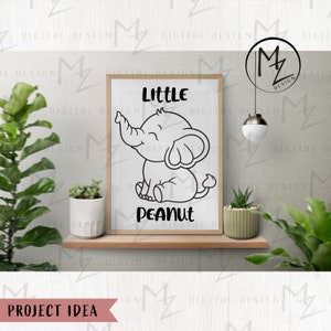 May include: A black and white illustration of a smiling elephant with the text "Little Peanut" on a white background. The illustration is framed and hanging on a wall.