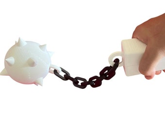 May include: A white spiked ball attached to a black chain with a white handle. The handle is held by a hand.