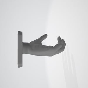 May include: A grey hand sculpture with an open palm, mounted on a white wall. The hand is positioned as if offering something.