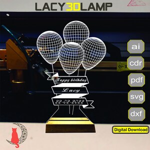 May include: A white 3D printed design of balloons with a banner that reads "Happy birthday Lacy 22-02-2022". The design is on a black background with a wooden base.