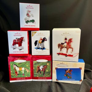 May include: A collection of Hallmark Keepsake ornaments, each featuring a pony design. The boxes are red, white, and blue, with the text "A Pony for Christmas" and "Collector's Series". Some ornaments are on a sled or skateboard.