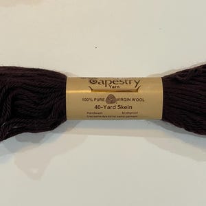May include: A skein of brown 100% pure virgin wool tapestry yarn. The label reads "Gapestry Yarn", "100% Pure Virgin Wool", "40-Yard Skein", "Handwash", "Mothproof", and "Use same dye lot for same garment".