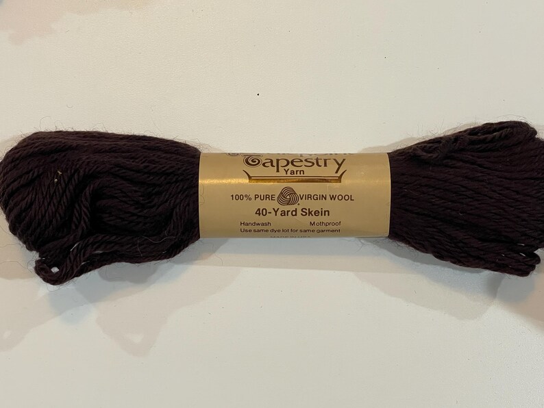 May include: A skein of brown 100% pure virgin wool tapestry yarn. The label reads "Gapestry Yarn", "100% Pure Virgin Wool", "40-Yard Skein", "Handwash", "Mothproof", and "Use same dye lot for same garment".