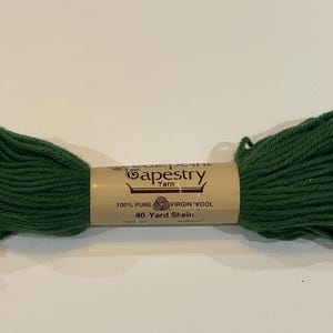 May include: A skein of green tapestry yarn, labeled "100% Pure Virgin Wool" and "40-Yard Skein".
