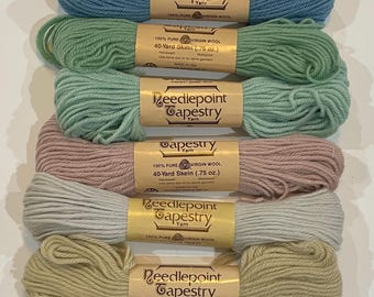May include: An assortment of eight skeins of Needlepoint Tapestry Yarn in various colors, including teal, blue, green, pink, gray, yellow, and brown. Each skein is labeled with details about the 100% virgin wool and the 40-yard length.