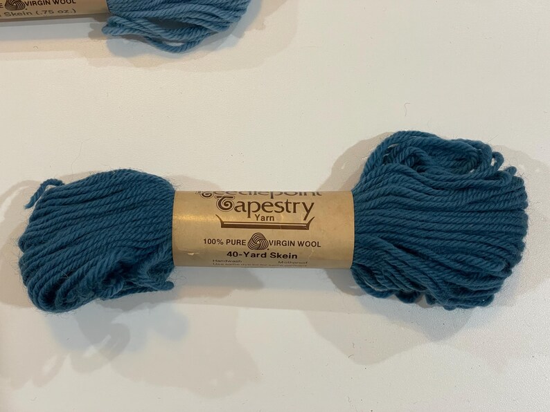 May include: A skein of teal-colored Needlepoint Tapestry Yarn, made of 100% pure virgin wool. The label reads "40-Yard Skein". The yarn is a vibrant teal color, perfect for various crafting projects.
