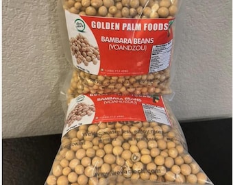 May include: Two clear plastic vacuum-sealed bags filled with round, tan-coloured Bambara beans. Each bag features a red and white label with the text Golden Palm Foods, Bambara Beans (Voandzou), and a net weight of 1kg printed on the front.