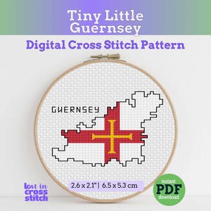 May include: A cross-stitch pattern of Guernsey, featuring the island's outline and flag design in red and yellow. The text "GUERNSEY" is above the design. The pattern is in a wooden embroidery hoop, measuring 2.6 x 2.1 inches.