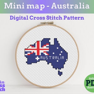 May include: A cross-stitch pattern of Australia in a wooden embroidery hoop. The map is blue with the Australian flag in the upper left corner. The word "AUSTRALIA" is below the flag. Text at the top reads "Mini map - Australia" and "Digital Cross Stitch Pattern".
