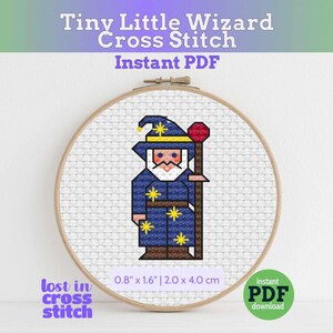 May include: A cross-stitch embroidery of a wizard in a blue robe and hat, holding a staff with a red orb. The design is in a wooden hoop, with the text "Tiny Little Wizard Cross Stitch Instant PDF". The design measures 2.0 x 4.0 cm.