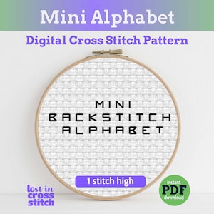 May include: A wooden embroidery hoop containing white Aida fabric with the black text MINI BACKSTITCH ALPHABET and 1 stitch high printed on it. The image includes the text Mini Alphabet Digital Cross Stitch Pattern and lost in cross stitch.