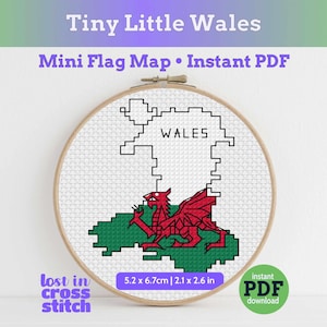 May include: A cross-stitch embroidery hoop depicting a pixelated map of Wales, with a red dragon and green base. The word "WALES" is above the map. The text "Tiny Little Wales" and "Mini Flag Map • Instant PDF" are at the top. The dimensions are 5.2 x 6.7cm.