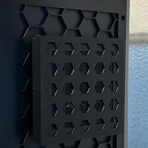 May include: Black computer case with a honeycomb pattern on the side and a removable black metal panel with a honeycomb pattern.