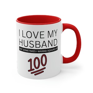 May include: White ceramic mug with a red rim and handle. The mug has black text that reads "I love my husband but sometimes I wanna square up 100". The number 100 has a red line through it.