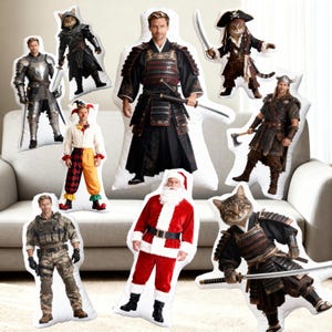 May include: A collection of character-shaped pillows, including a knight, a samurai, a pirate cat, a Santa Claus, a soldier, a jester, and a Viking. The pillows are white with full-body images of the characters.