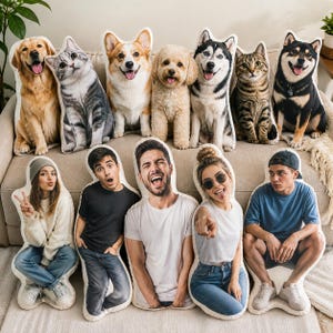 K&ouml;nnte beinhalten: Eine Sammlung von Pl&uuml;schkissen mit Bildern von Hunden, Katzen und Menschen. Zu den Hundekissen geh&ouml;ren ein Golden Retriever, ein Husky, ein Corgi und ein Pudel. Die Katzenkissen zeigen eine graue Tabby. Die Personenkissen zeigen verschiedene Gesichtsausdr&uuml;cke.