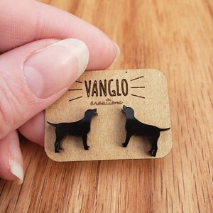 May include: A pair of black dog silhouette earrings on a brown card with the text "VANGLO creations".