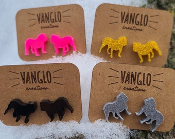 May include: Four pairs of bulldog earrings on display cards. The earrings are made of resin and come in pink, yellow, black, and silver glitter. Each card has the text "VANGLO creations" printed on it.