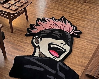 May include: A custom-shaped area rug featuring a graphic illustration of an anime character with spiky pink hair, a black blindfold, and a wide, laughing mouth with a visible pink tongue, set against a dark black clothing base.