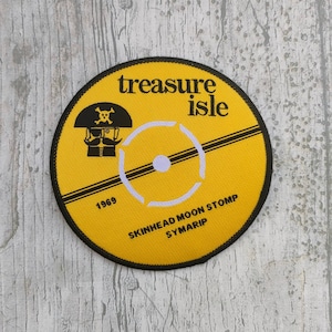 May include: Yellow and black circular patch with a pirate illustration and the text "treasure isle" and "Skinhead Moon Stomp Symarlp 1969".