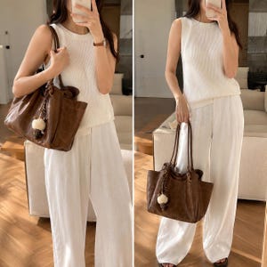 Brown leather tote bag for women featuring a spacious vintage-inspired design, double shoulder straps, magnetic closure, and decorative charm, ideal for work, commuting, travel, and everyday use.