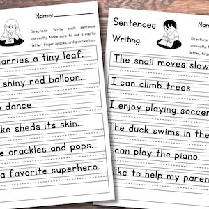 May include: Two white educational worksheets titled Sentences Writing with lines for handwriting practice. Each page features a cartoon illustration of a child writing and lists sentences to copy, including The ant carries a tiny leaf and The snail moves slowly.