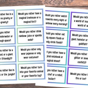 May include: Two sheets of paper with "Would you rather" questions in black text inside colorful boxes. Questions include choices like "live in the Arctic or the jungle?" and "ride a giant hamster or a giant goldfish?"