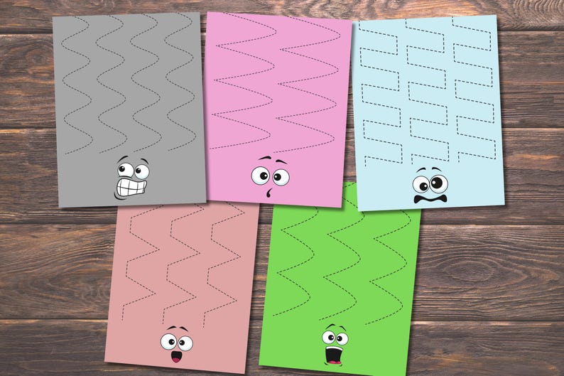 May include: Five colorful sheets of paper with zig-zag lines and cartoon faces. The sheets are gray, pink, light blue, rose, and green. The lines are dotted, and the faces have different expressions.