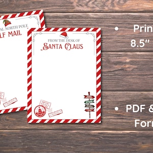 Peut inclure: Deux feuilles de papeterie sur le th&egrave;me de No&euml;l avec des bordures ray&eacute;es rouges et blanches. L'une indique "Official North Pole Elf Mail", l'autre "From the Desk of Santa Claus". Les deux pr&eacute;sentent des timbres festifs et un panneau indicateur.
