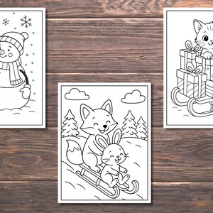 May include: Three black and white coloring pages featuring winter scenes. One shows a snowman with a hat and scarf, another a fox and rabbit sledding, and the last a cat on a sled filled with gifts. All are on a wood grain background.