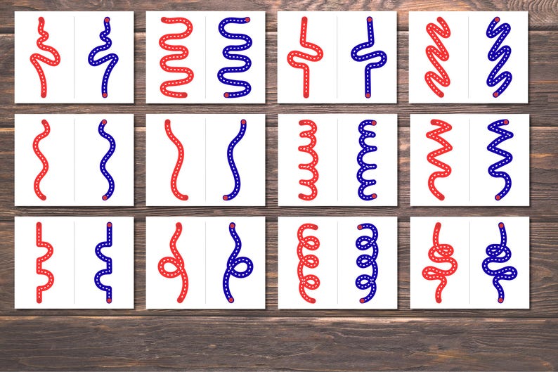 Pode incluir: Um conjunto de doze cart&otilde;es brancos, cada um dividido ao meio, exibindo desenhos de linhas curvas vermelhas e azuis. As linhas variam em forma, incluindo padr&otilde;es ondulados, zigue-zague e espirais. Os cart&otilde;es est&atilde;o dispostos sobre uma superf&iacute;cie de madeira.