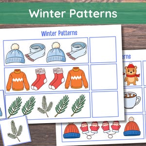 May include: Two sheets of paper with the text "Winter Patterns" and illustrations of winter clothing and a bear. The illustrations include hats, scarves, sweaters, socks, mittens, and pine branches. The background is a wooden surface.