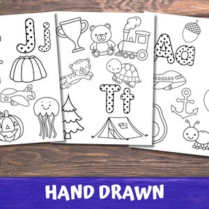 May include: Black and white printable colouring pages featuring the alphabet letters J, T, and A with various illustrations.  The letters are decorated with polka dots.  The illustrations include a jelly, a plane, a pumpkin, a jellyfish, a tree, a trophy, a teddy bear, a train, a turtle, a tent, an aeroplane, an anchor, an apple, and an astronaut.