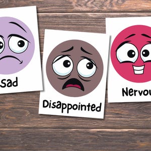 May include: Three cards with cartoon faces representing emotions. The first card shows a sad face in a purple circle with the word "sad". The second card has a disappointed face in a brown circle. The third card shows a nervous face in a pink circle with the word "Nervous".