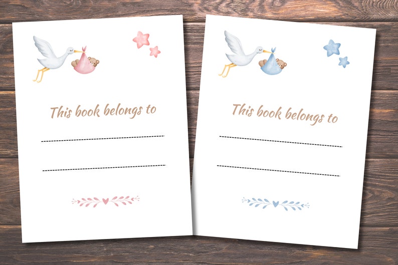 May include: Two blank bookplates featuring a stork carrying a baby in a blanket. The bookplate on the left has a pink blanket and stars, while the bookplate on the right has a blue blanket and stars. The text "This book belongs to" is printed on both bookplates.