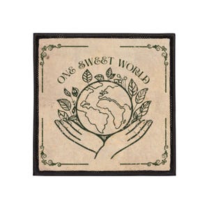 May include: Square patch with the words "ONE SWEET WORLD" surrounding a globe held by hands. The design is in green on a tan background with a black border. Leaves and decorative flourishes complete the design.
