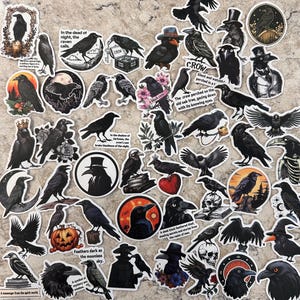 May include: A collection of black crow stickers with various designs. Some stickers feature crows with top hats, perched on books, or with floral accents. Text includes phrases like "In the dead of night, the raven calls" and "A sleek black feathered thief."