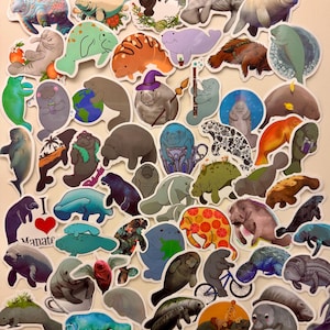 May include: A collection of colorful manatee stickers in various designs. Some stickers feature manatees with floral patterns, holding objects, or in whimsical settings. The stickers are in shades of blue, green, orange, and purple.