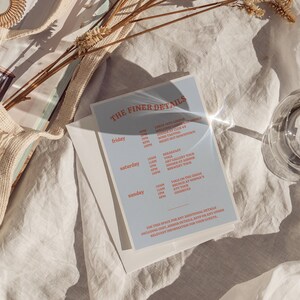 May include: A blue and white card with the text "THE FINER DETAILS" and a schedule of events for Friday, Saturday, and Sunday. The events include wine tasting, yoga, art gallery tours, brunch, and a cookie bar.