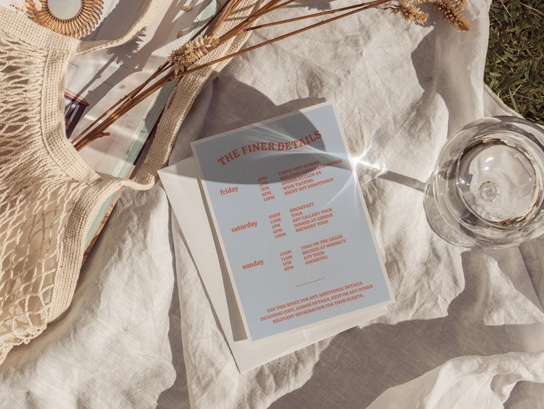 May include: A blue and white card with the text "THE FINER DETAILS" and a schedule of events for Friday, Saturday, and Sunday. The events include wine tasting, yoga, art gallery tours, brunch, and a cookie bar.