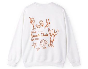 May include: White sweatshirt with an orange graphic design that says "Leila's Beach Club Est. 2024" with illustrations of a cocktail, an oyster, a seashell, a starfish, and a lobster.