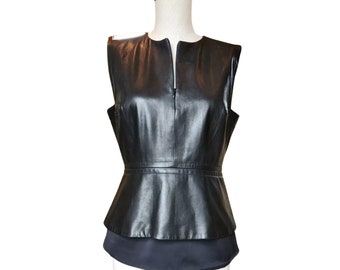 May include: A black leather sleeveless top with a peplum hem and a V-neckline.