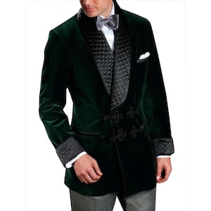 May include: A dark green velvet blazer with a black quilted lapel and cuffs. The blazer features black decorative closures and a white pocket square. A bow tie is visible.
